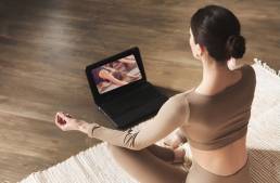 Online yoga - woman practicing online yoga.